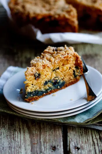 Ina Garten's Blueberry Crumb Cake A slice of blueberry crumb cake on a plate