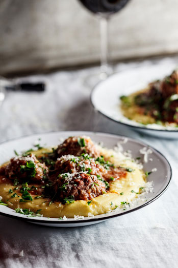 Meatballs baked in tomato sauce on polenta