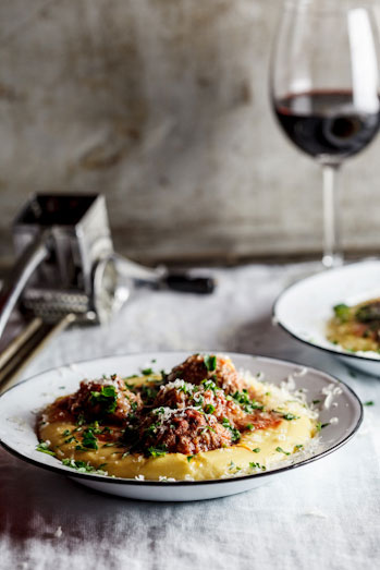 Meatballs baked in tomato sauce on polenta