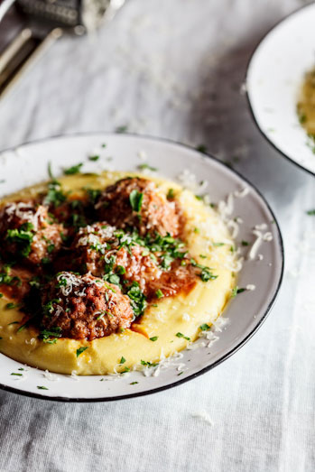 Meatballs baked in tomato sauce on polenta