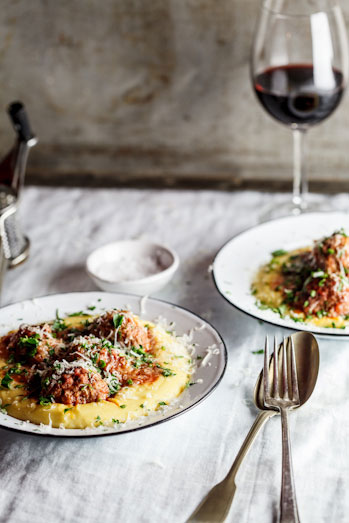 Meatballs baked in tomato sauce on polenta