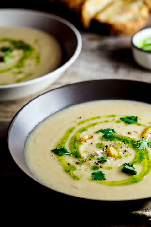Celeriac & roasted garlic soup with parsley oil