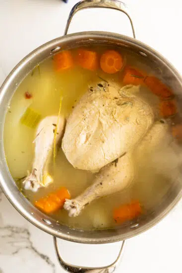 Cooked chicken in stock.