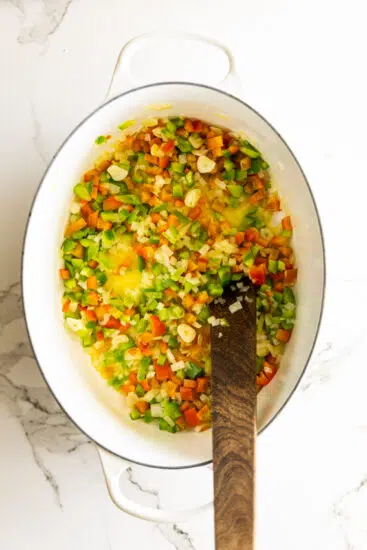 Aromatics cooked in butter in pot.