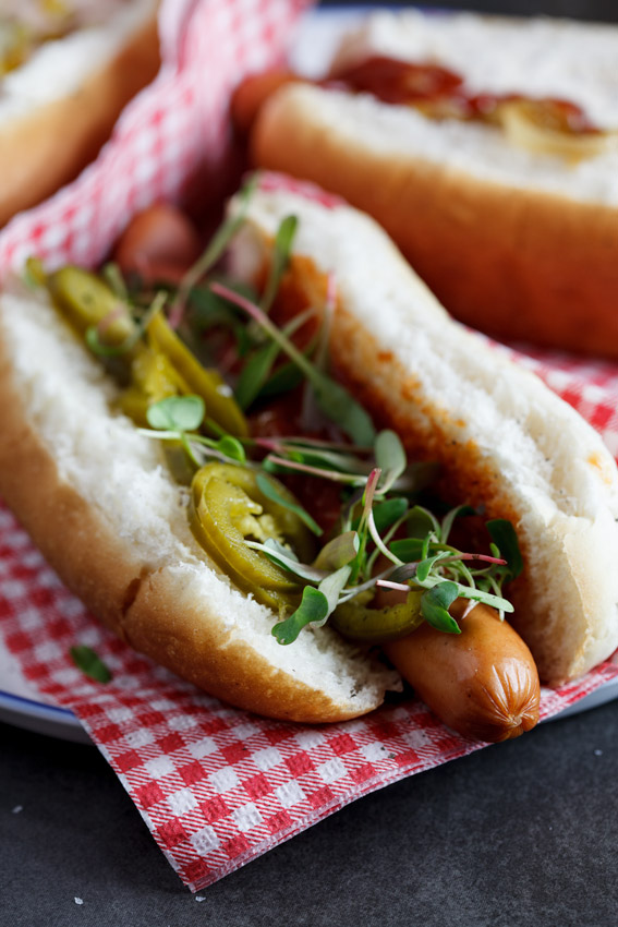 Hot dog with pickled jalapeños and salsa