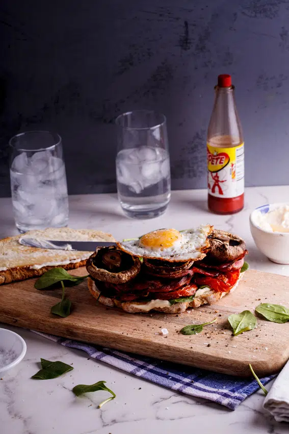 What could be better than a proper breakfast with all the trimmings on a sandwich? Not much, to be honest. These enormous sandwiches are a great way to jazz up your usual breakfast and serve it in a fun way. It's also just absolutely delicious. Every bite is filled with smoky, saltiness from the bacon, sweetness from the mushrooms and tomatoes and creaminess from the perfectly fried eggs. Along with that you get crunch from the bread and smooth from the mayo. I mean. Seriously.