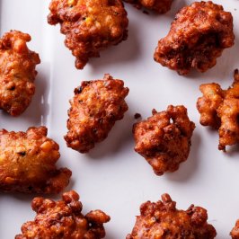 Jalapeño corn fritters on white baking sheet