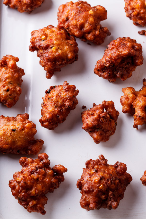 Jalapeño corn fritters on white baking sheet