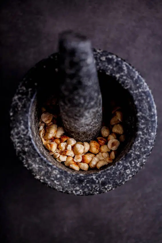 Roasted hazelnuts in pestle and mortar Roasted hazelnuts in pestle and mortar