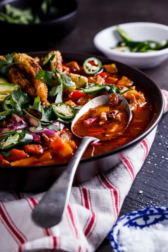 Aromatic Mexican chicken soup with sweet, charred baby corn makes for a showstopping meal when served with fresh jalapeños and avocado.