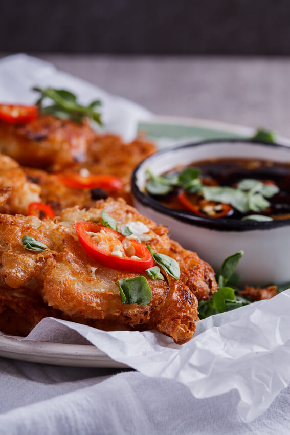 Crisp and golden onion and feta cheese fritters with sweet and spicy chilli soy dipping sauce. This recipe is perfect for a starter or as a snack.