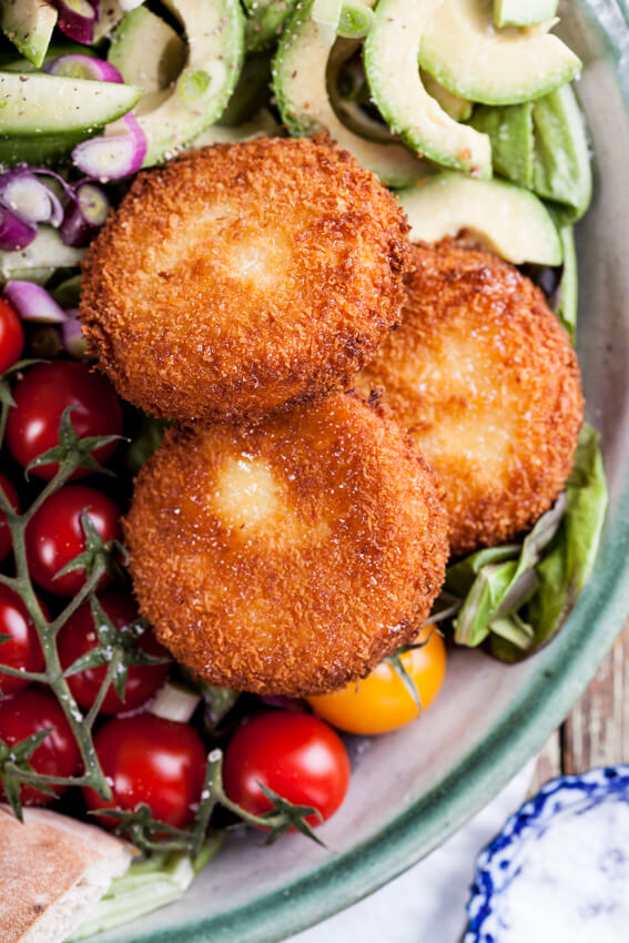 Colorful, healthy Greek salad recipe served with crisp, golden fried feta cheese, drizzled with honey, dressed with a lemon and oregano salad dressing.