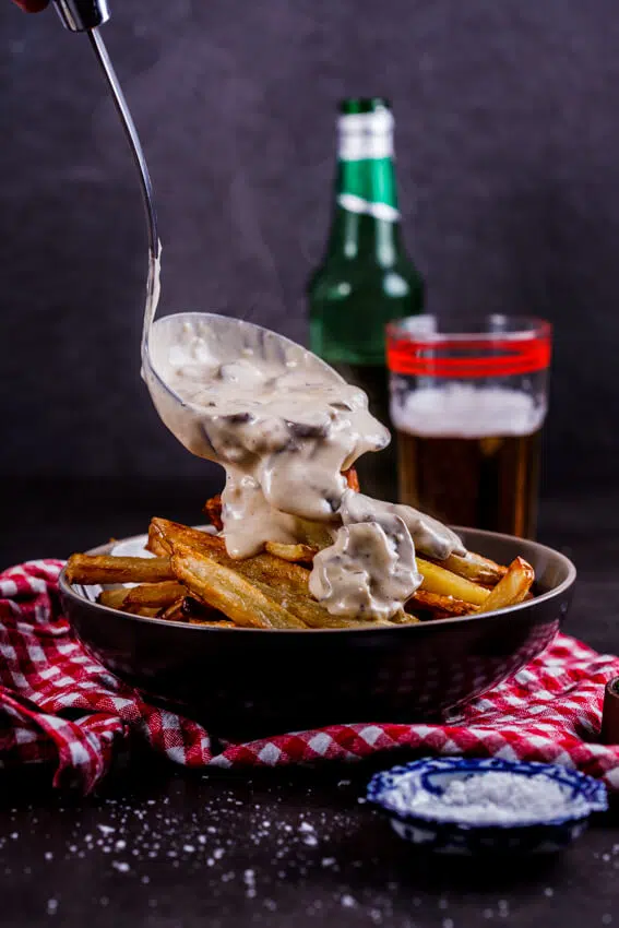 Saucy fries is the ultimate lazy, indulgent meal. Crispy oven-baked French fries topped with creamy mushroom sauce? Yes please!