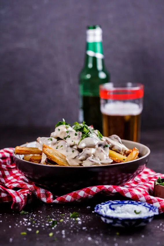 Saucy fries is the ultimate lazy, indulgent meal. Crispy oven-baked French fries topped with creamy mushroom sauce? Yes please!
