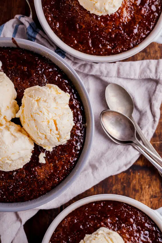 South African Malva pudding is rich, syrupy and absolutely delicious served with quick and easy frozen custard. The ultimate dessert.
