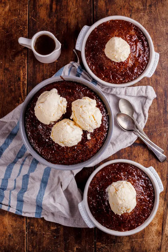 South African Malva pudding is rich, syrupy and absolutely delicious served with quick and easy frozen custard. The ultimate dessert.