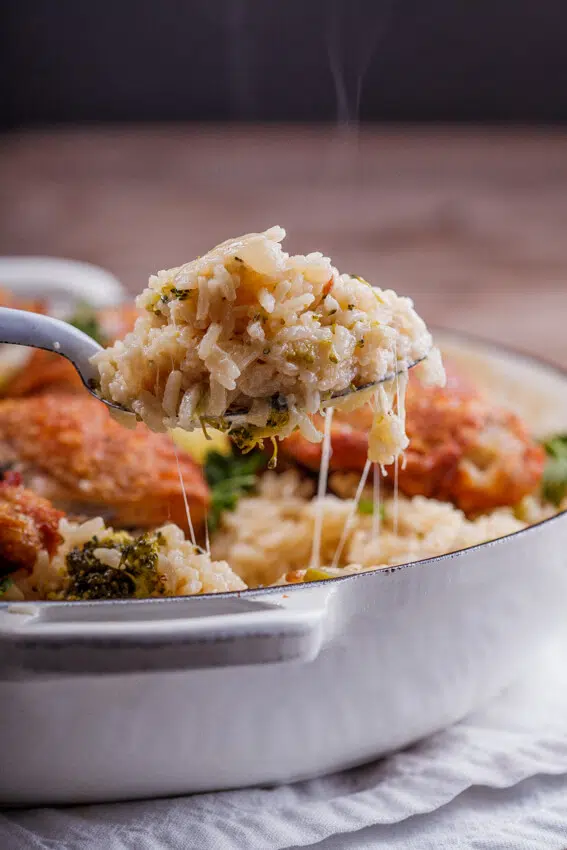 Crispy chicken thighs on cheesy broccoli rice