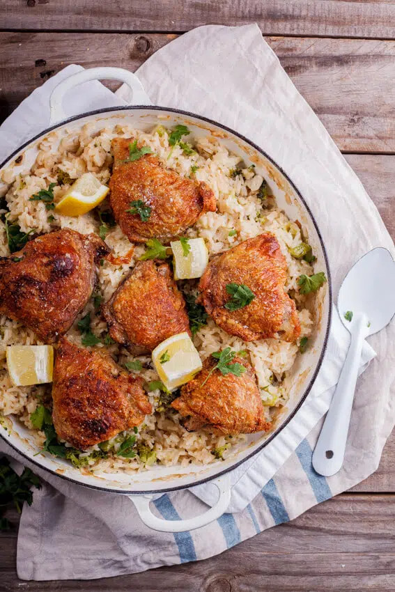 Crispy chicken thighs on cheesy broccoli rice