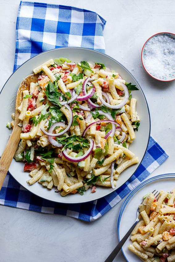 Easy creamy curried macaroni salad on blue cloth.