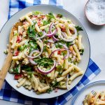 Easy creamy curried macaroni salad on blue cloth.