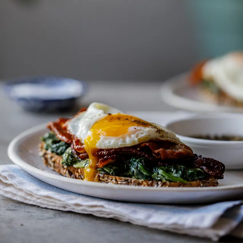 Bacon, egg and creamed spinach breakfast toast