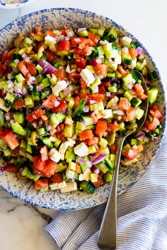Easy chopped salad with tomatoes, cucumbers, feta and olives.
