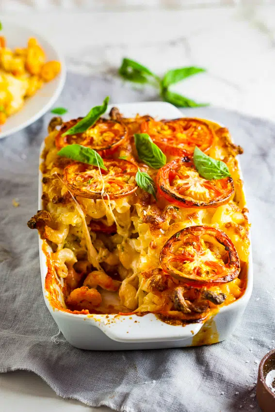 Caprese baked mac and cheese with fresh tomatoes and basil pesto.