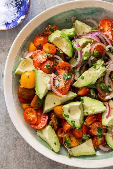 Tomato avocado salad in serving bowl