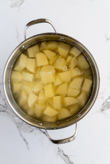 Chopped potatoes in a pot of water.
