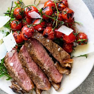 Grilled steak with blistered tomatoes