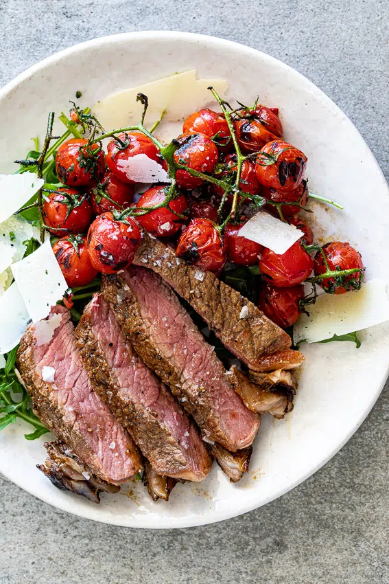 Grilled steak with blistered tomatoes