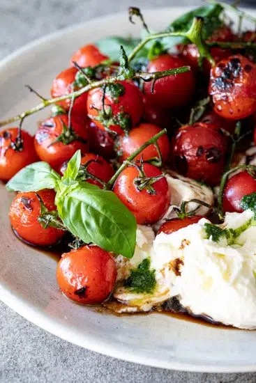 Grilled tomato caprese salad with Balsamic vinaigrette.
