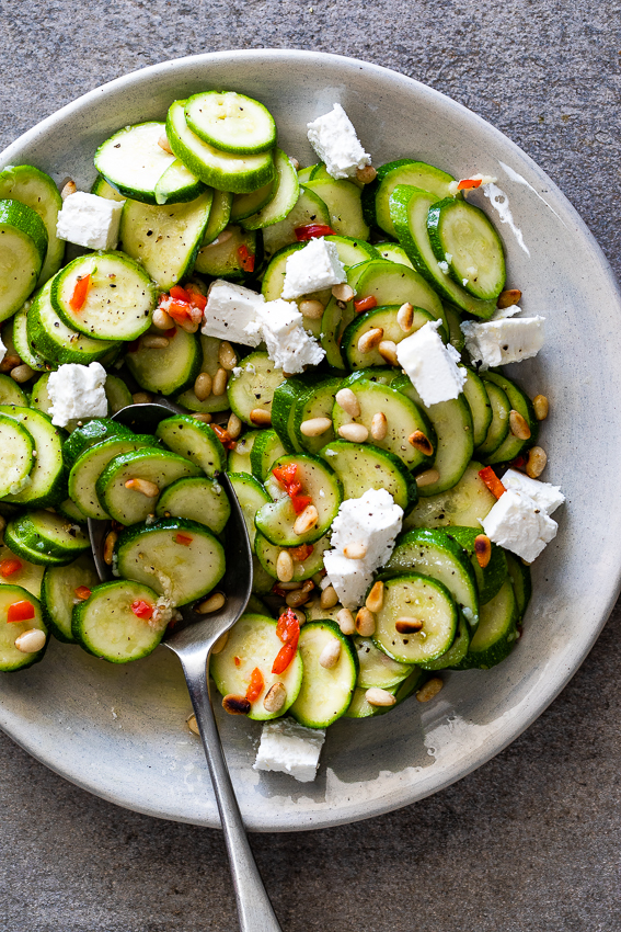 Marinated zucchini salad with feta and pine nuts