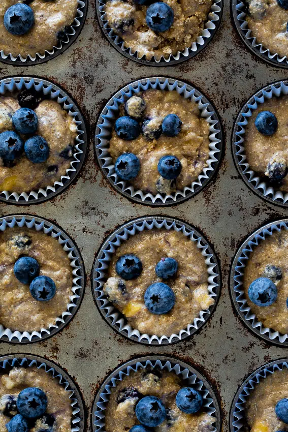 Healthy blueberry muffin batter in muffin tin