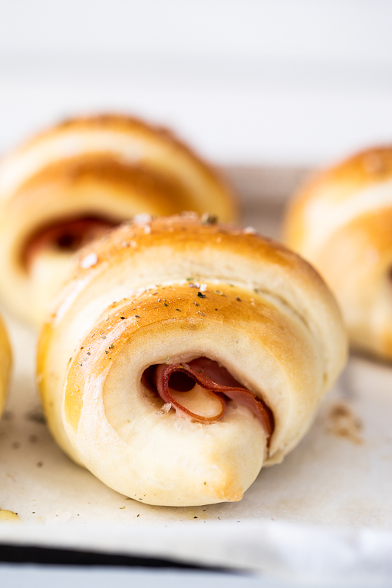 Homemade crescent rolls filled with ham and cheese.