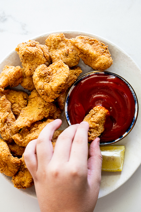 Chicken nuggets with ketchup.