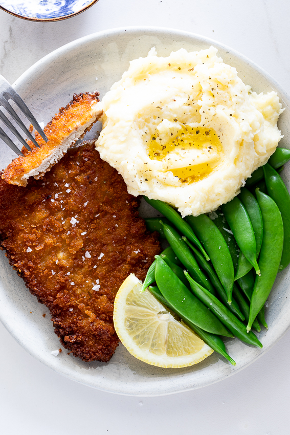 Pork schnitzel with mashed potatoes and vegetables. 