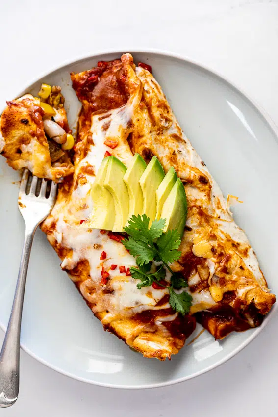 Vegetarian enchiladas served with avocado.