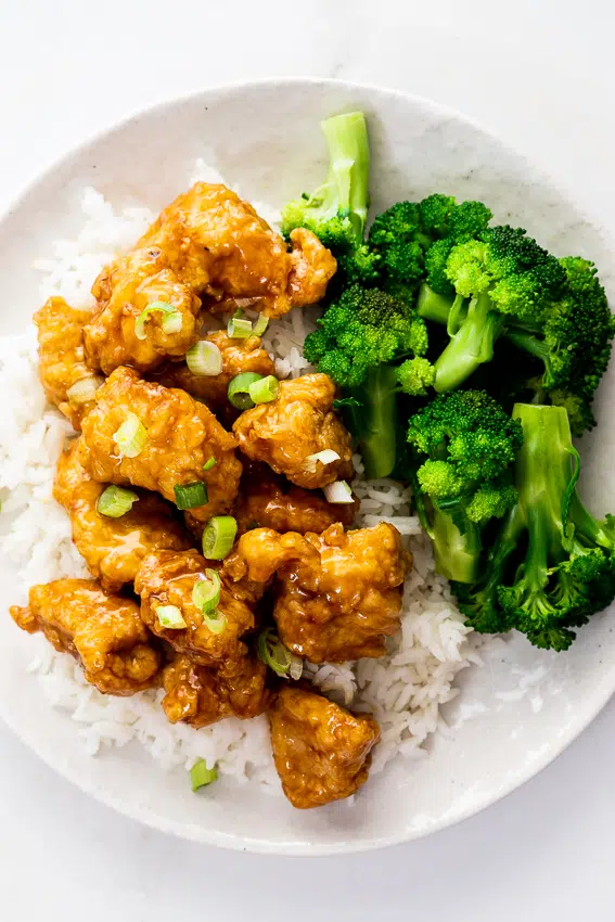 Crispy orange chicken with rice and broccoli.