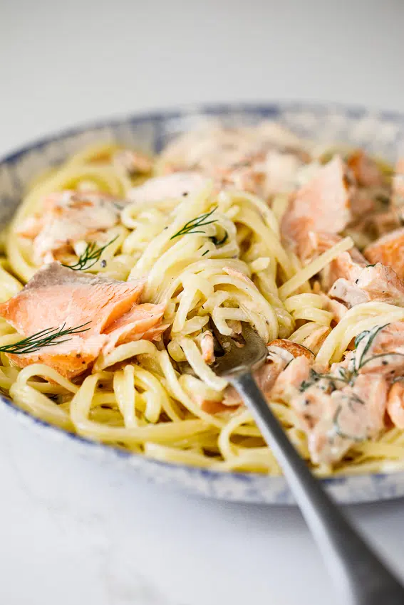 Salmon in a creamy dill sauce on pasta.