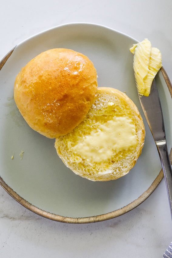 Fluffy white bread rolls with butter.
