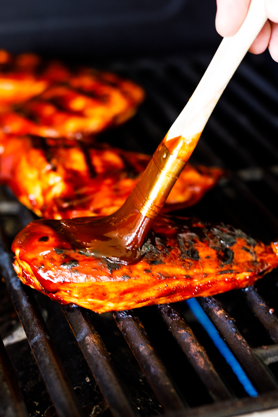 Juicy BBQ chicken breasts on the grill.