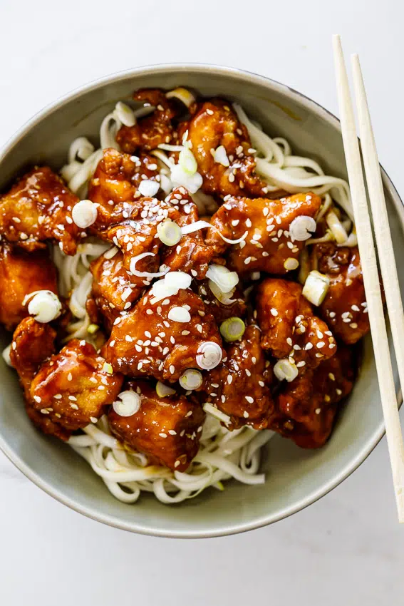 Crispy sesame chicken with noodles.