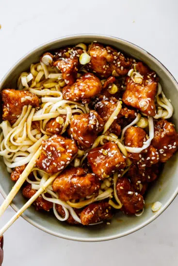 Crispy sesame chicken with noodles.