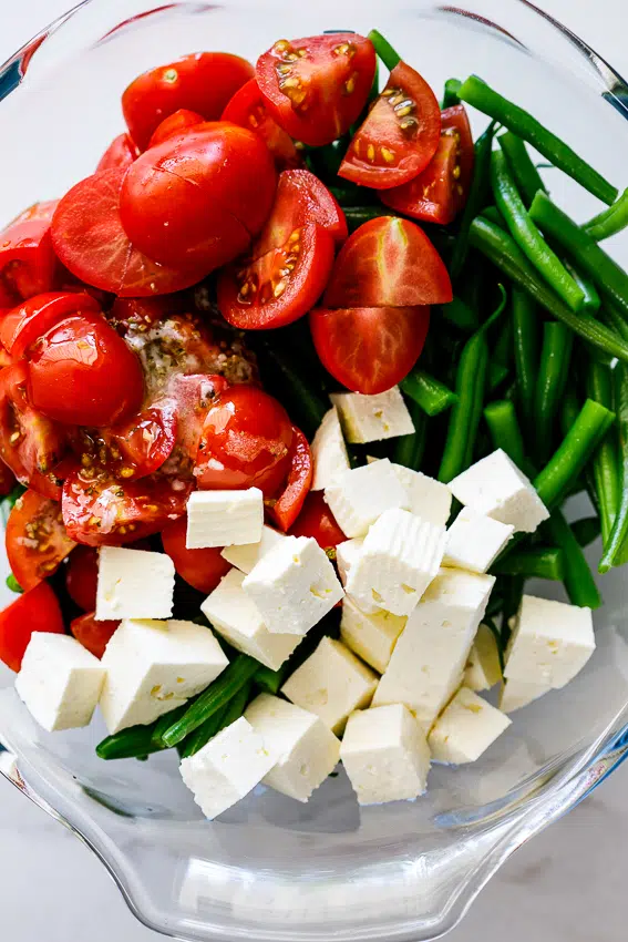 Easy tomato feta green bean salad with garlic lemon vinaigrette.