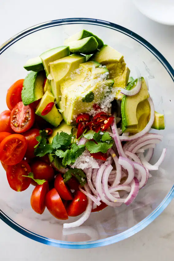 Guacamole salad with avocado, tomato, onion and cilantro.