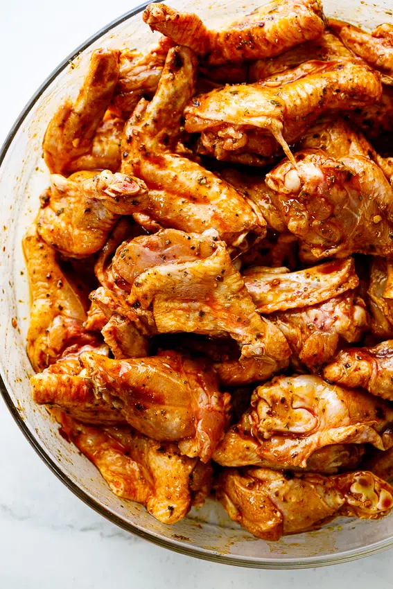 Chicken wings marinating in lemon herb marinade.