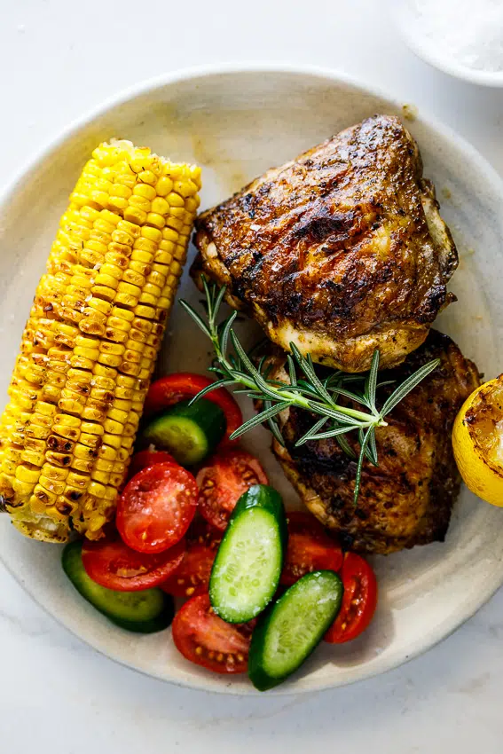 Easy grilled chicken thighs with corn and salad.