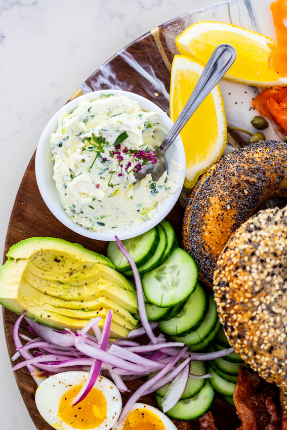 Scallion cream cheese on bagel board.