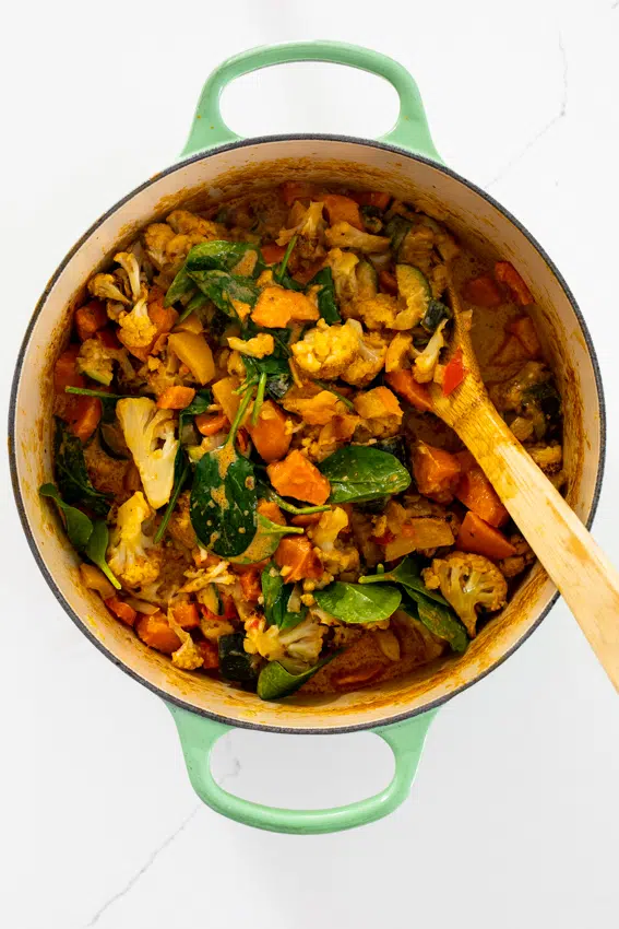 Vegetable curry ingredients in pot.